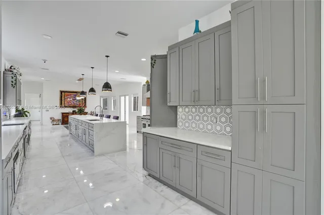 a living room with furniture kitchen view and a large window