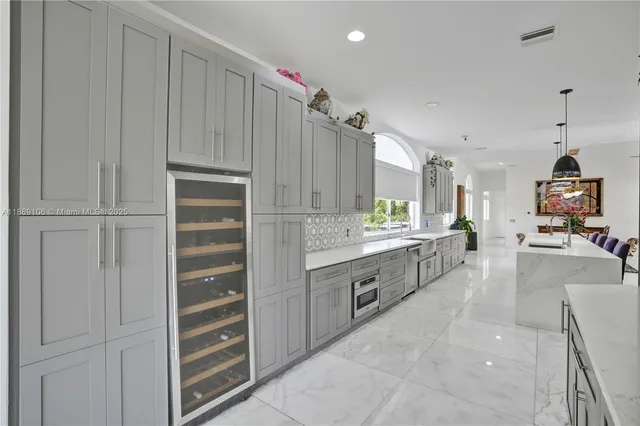 a view of a dining room with furniture a chandelier and wooden floor