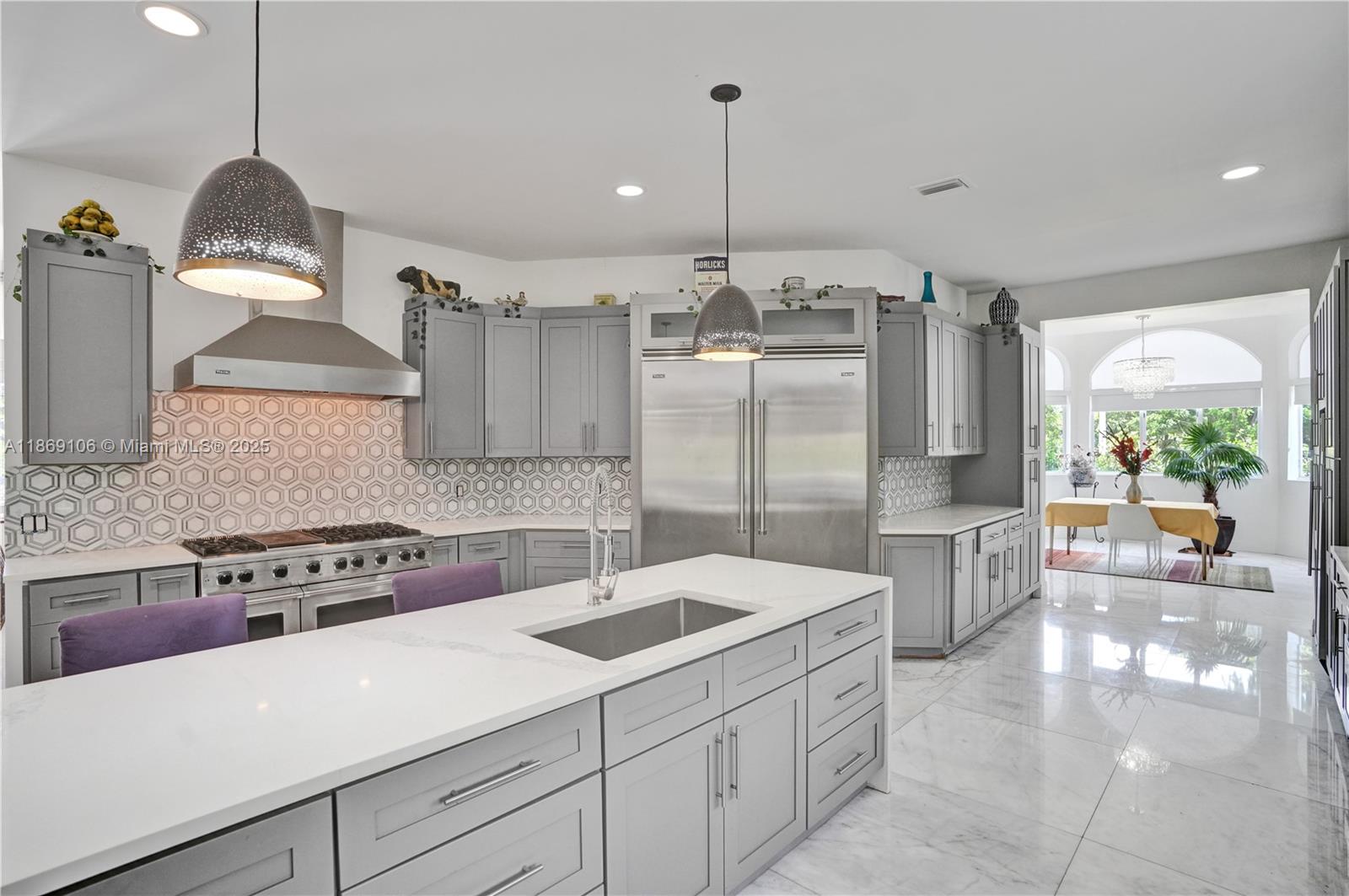 2691 Southwest 139th Terrace Davie, FL 33330 - Photo 26 of 55 a kitchen with a sink a stove and chairs