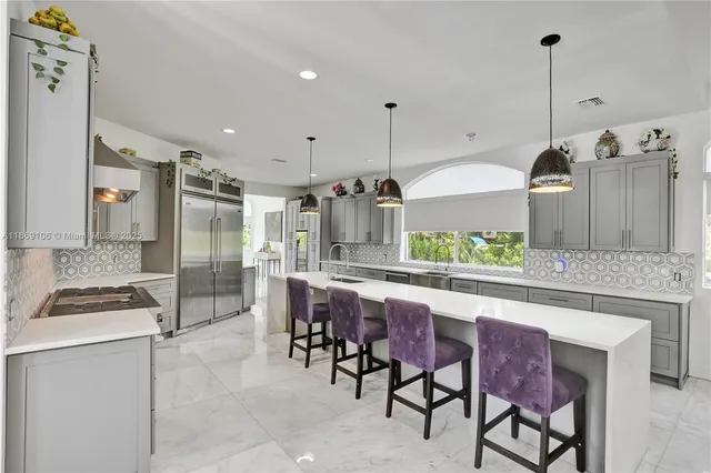 a view of a living room kitchen and a wooden floor