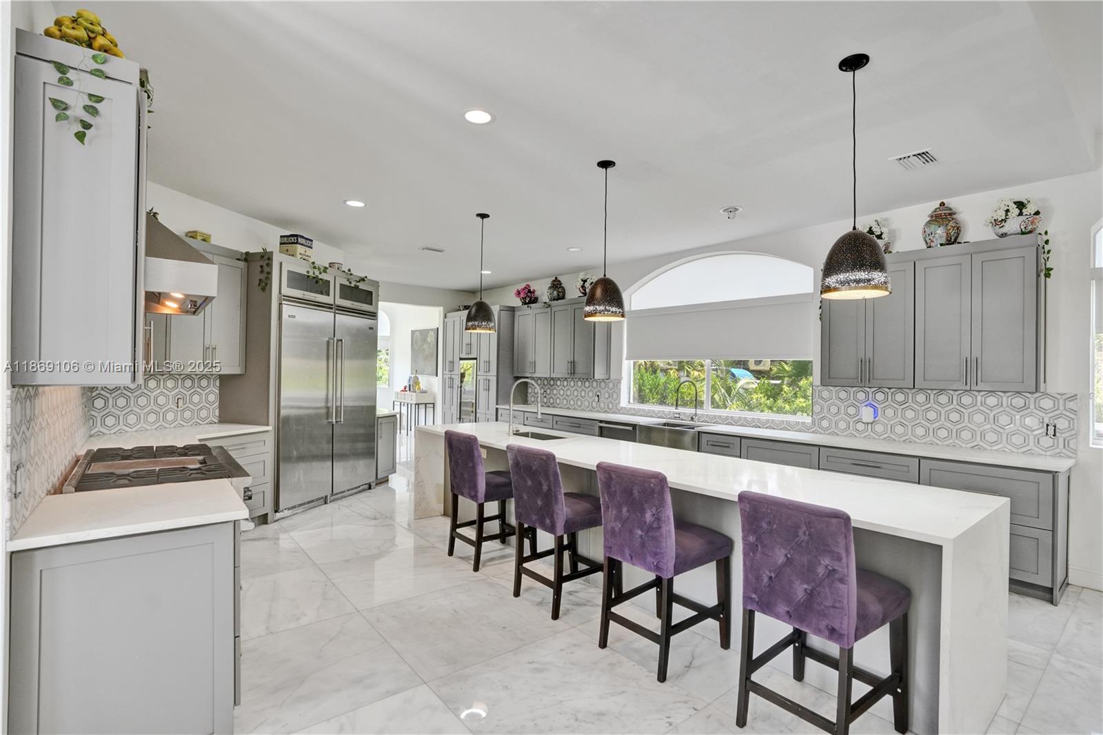 2691 Southwest 139th Terrace Davie, FL 33330 - Photo 27 of 55 a kitchen with stainless steel appliances kitchen island granite countertop a table and chairs in it