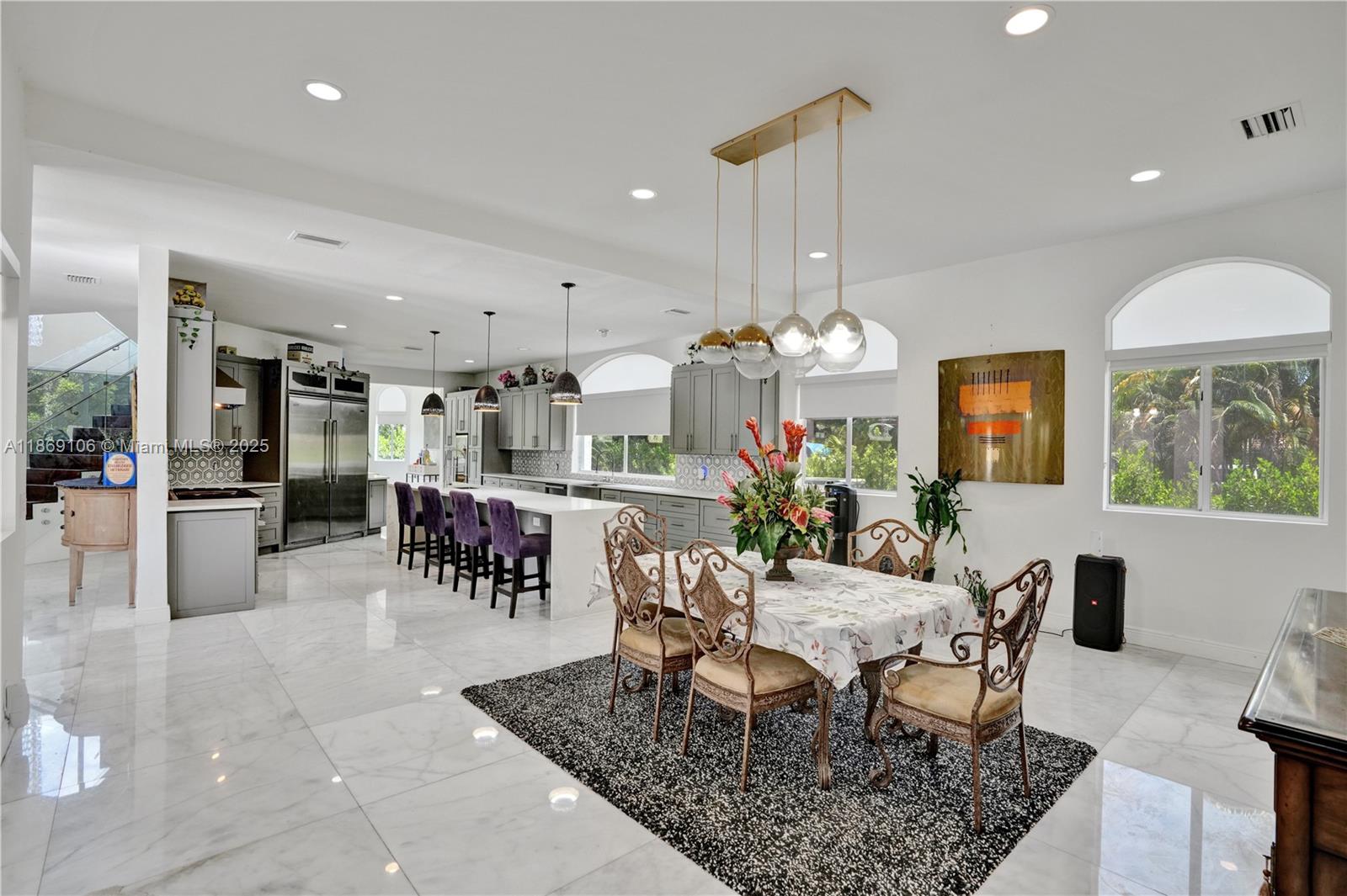 2691 Southwest 139th Terrace Davie, FL 33330 - Photo 29 of 55 a view of a dining room with furniture a chandelier and wooden floor
