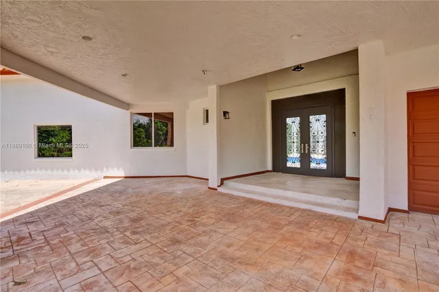 a view of a hallway with wooden floor and windows