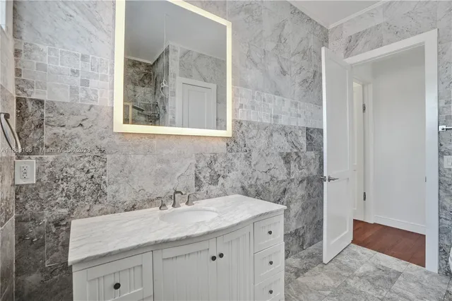 an aerial view of residential houses with outdoor space and trees