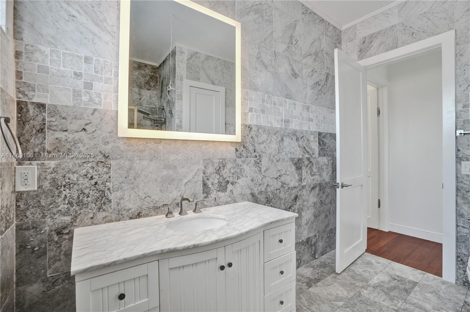 2691 Southwest 139th Terrace Davie, FL 33330 - Photo 50 of 55 a bathroom with a granite countertop sink a toilet and a mirror