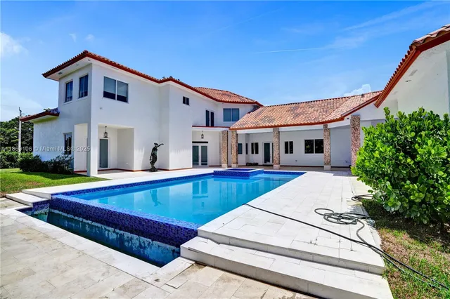 a view of house with swimming pool and porch