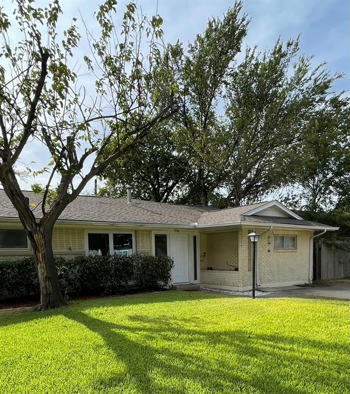 a front view of a house with a garden and yard