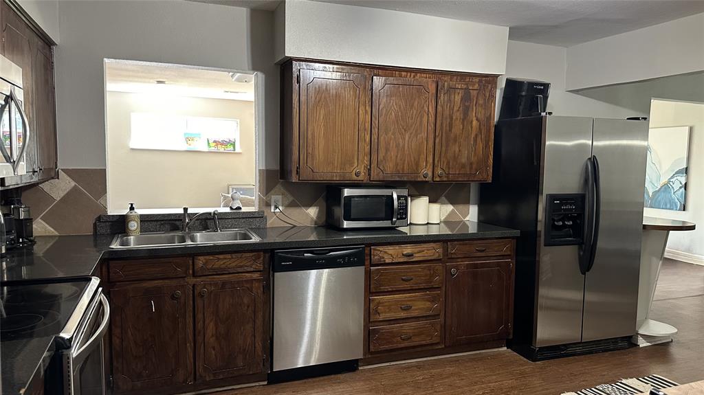 13533 Emeline Street Farmers Branch, TX 75234 - Photo 11 of 29 a kitchen with stainless steel appliances granite countertop a refrigerator and a stove