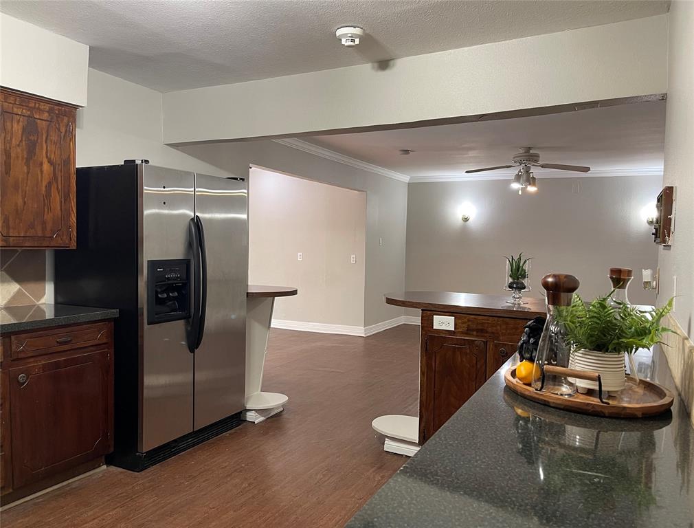 13533 Emeline Street Farmers Branch, TX 75234 - Photo 12 of 29 a kitchen with stainless steel appliances kitchen island granite countertop a refrigerator and a stove