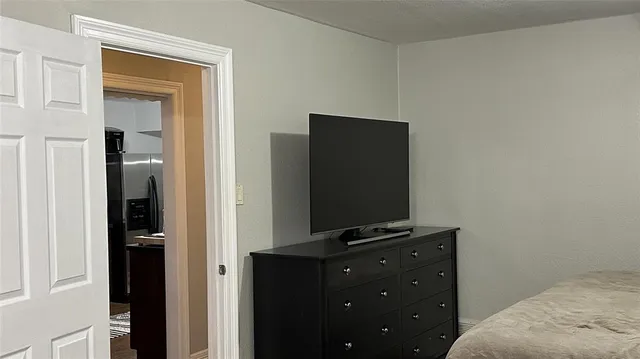 a bedroom with a bed and television