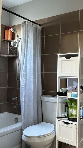 a bathroom with a toilet a sink and a shower