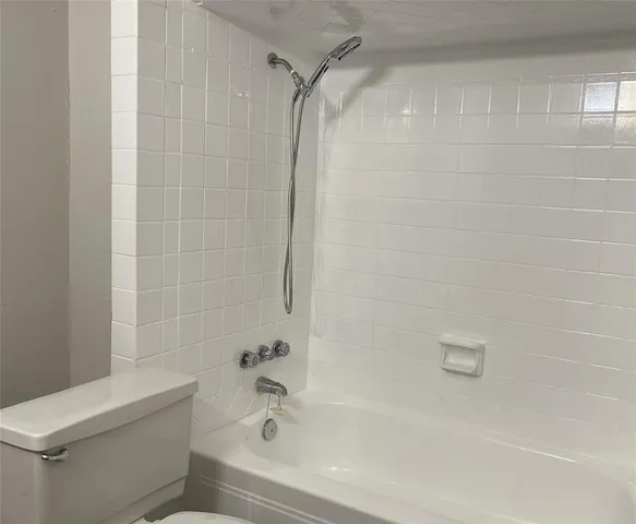a bathroom with a bathtub and a toilet