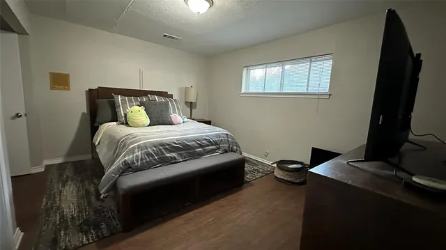 a bedroom with a bed and a flat tv screen
