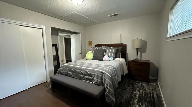 a bedroom with a bed and a window