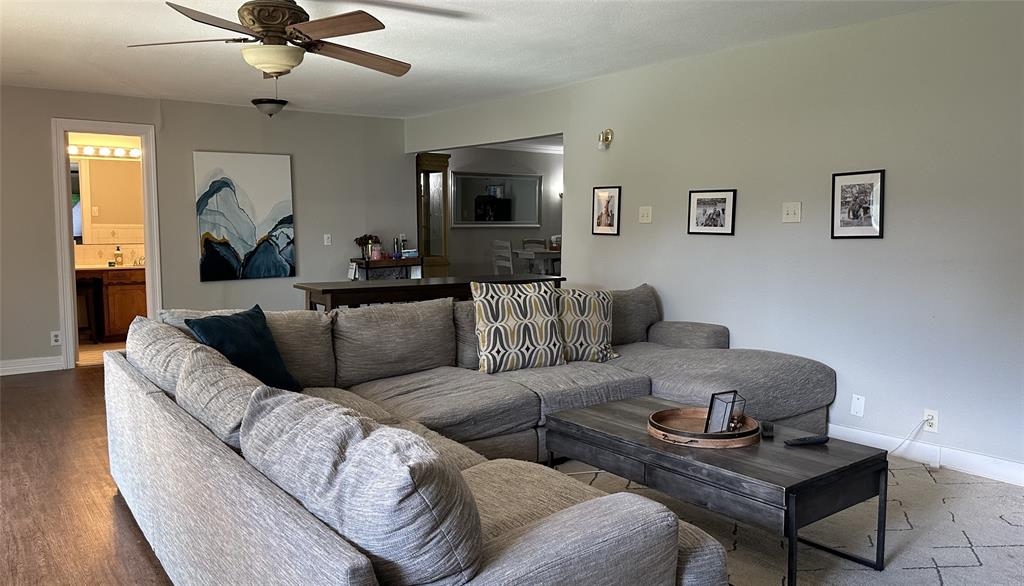 13533 Emeline Street Farmers Branch, TX 75234 - Photo 3 of 29 a living room with a couch and a flat screen tv