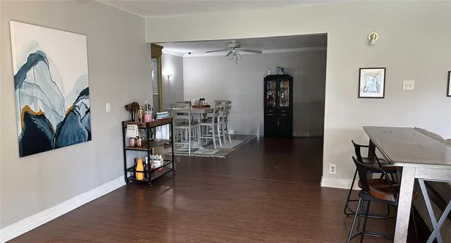 a view of a workspace with furniture and wooden floor