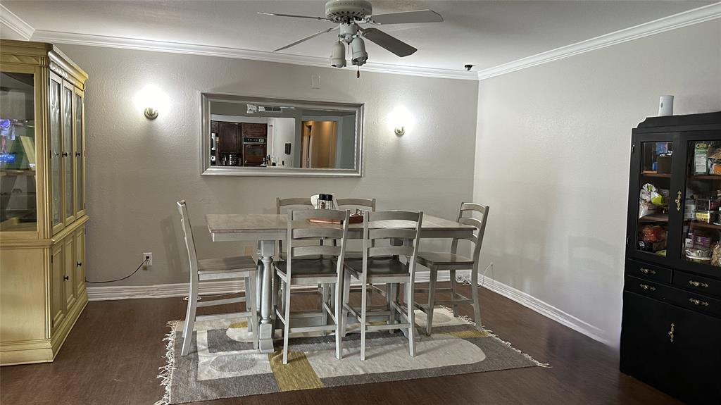 13533 Emeline Street Farmers Branch, TX 75234 - Photo 6 of 29 a dining room with wooden floor a glass table and chairs