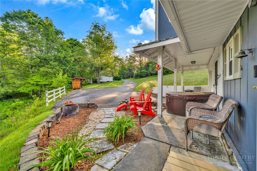 242 Ladd Parson Road Crumpler, NC 28617 - Photo 5 of 36 a backyard of a house with table and chairs