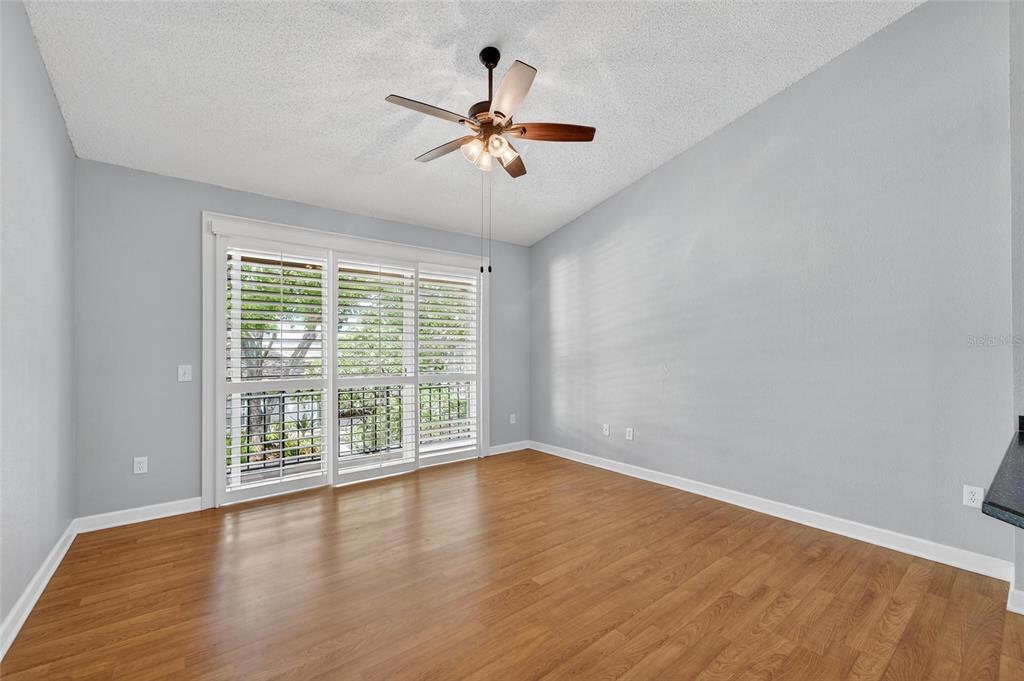 820 Normandy Trace Road Tampa, FL 33602 - Photo 16 of 49 a view of an empty room with wooden floor and a window