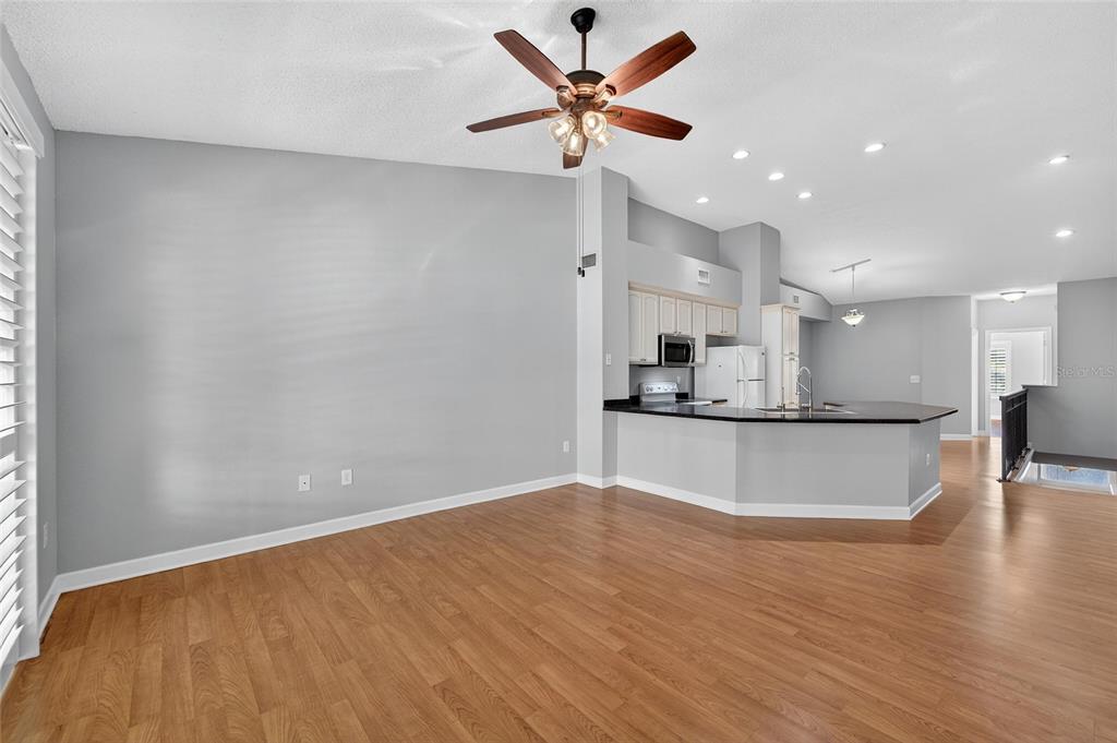 820 Normandy Trace Road Tampa, FL 33602 - Photo 19 of 49 a view of kitchen with kitchen island a sink wooden floor and a large window