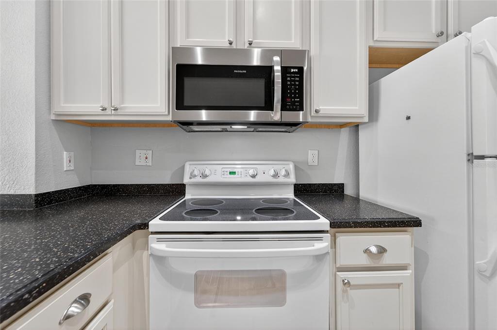 820 Normandy Trace Road Tampa, FL 33602 - Photo 25 of 49 a kitchen with a stove and a microwave