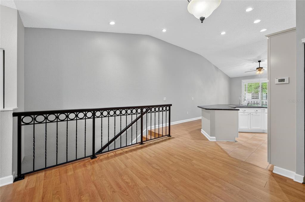 820 Normandy Trace Road Tampa, FL 33602 - Photo 29 of 49 a view of a hallway with wooden floor and staircase