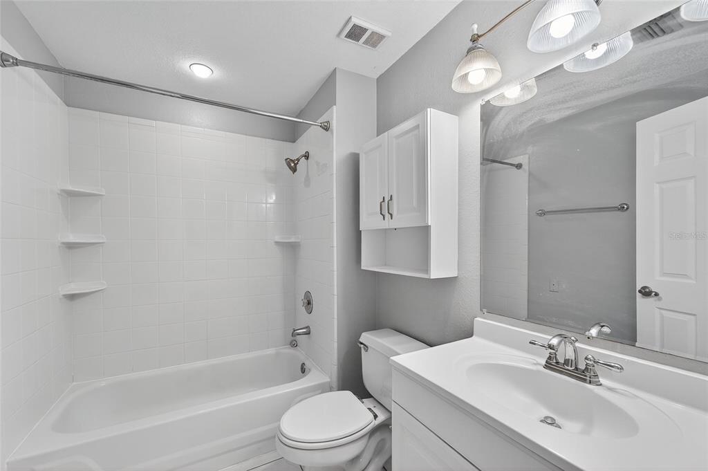 820 Normandy Trace Road Tampa, FL 33602 - Photo 31 of 49 a bathroom with a bathtub shower sink vanity mirror and toilet