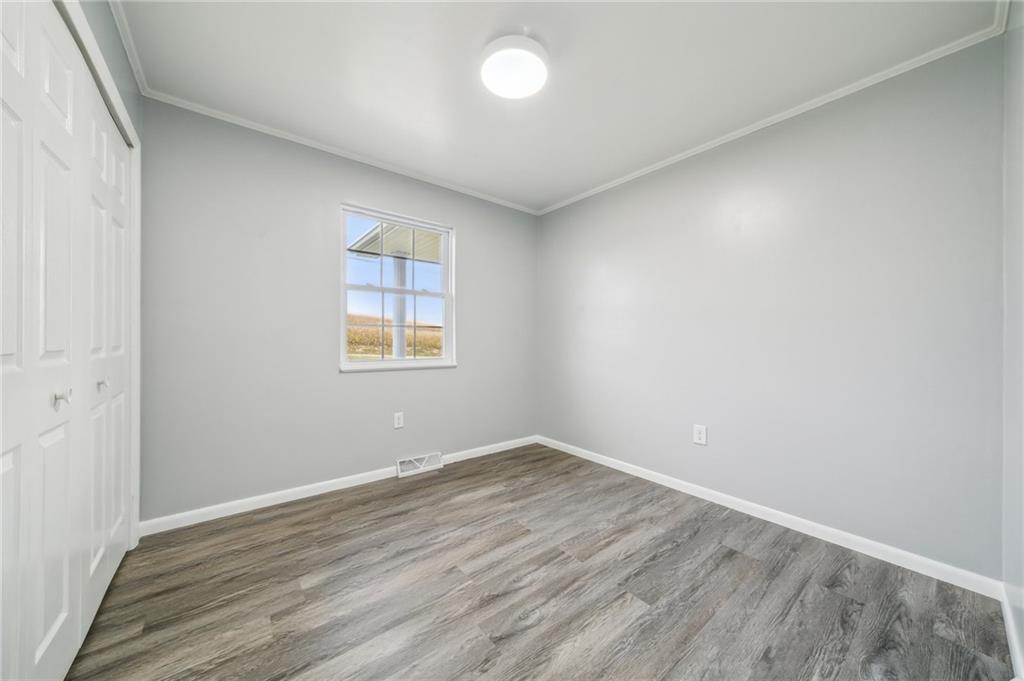 133 Ulery Road Acme, PA 15610 - Photo 16 of 38 an empty room with wooden floor and windows