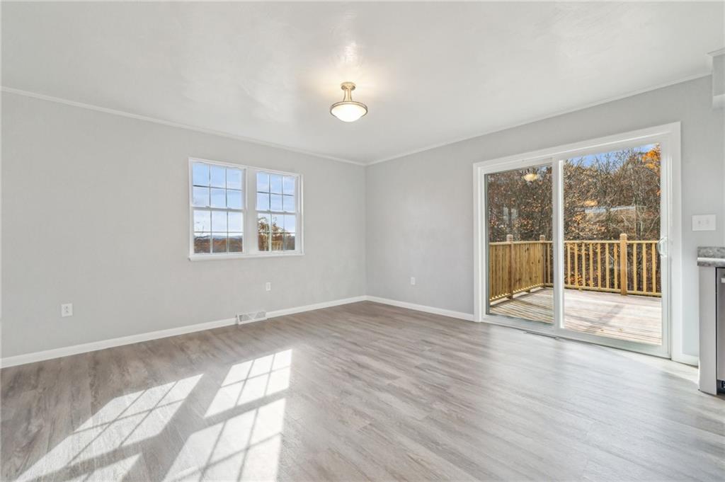 133 Ulery Road Acme, PA 15610 - Photo 8 of 38 a view of an empty room with wooden floor and a window