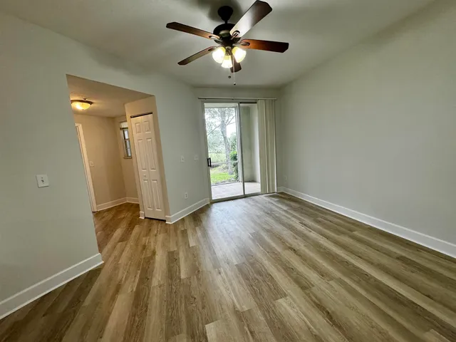 wooden floor in an empty room with a window