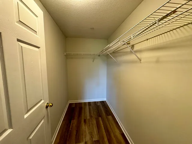 a view of a room with wooden floor and a window