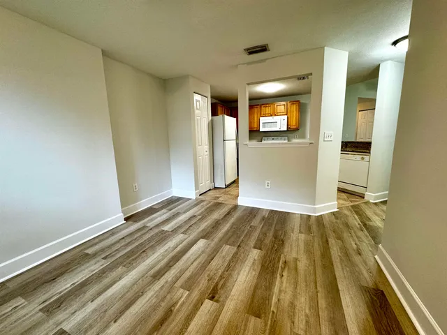 a view of a room with wooden floor and stairs