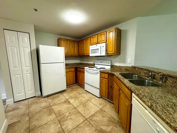 a kitchen with a stove a refrigerator and a sink