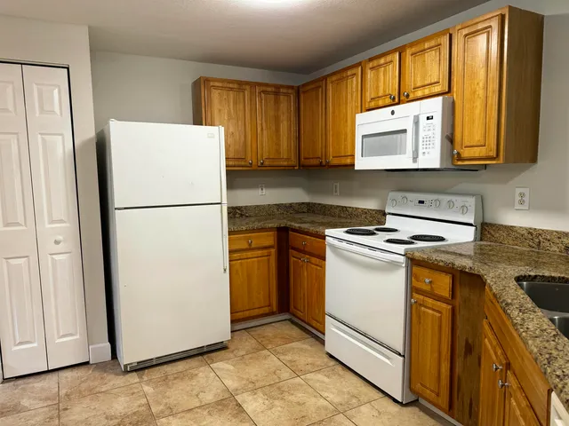 a kitchen with a white cabinets and white appliances