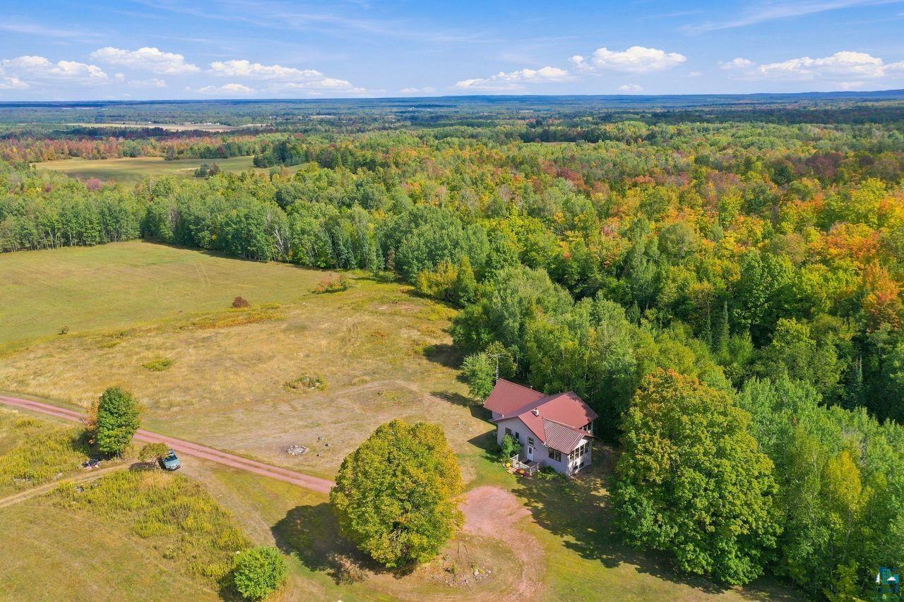 65889 Old County Road Marengo, WI 54855 - Photo 40 of 44 Expansive natural landscape with a residence nestled among mature trees