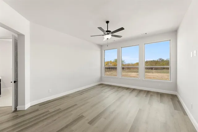 an empty room with wooden floor