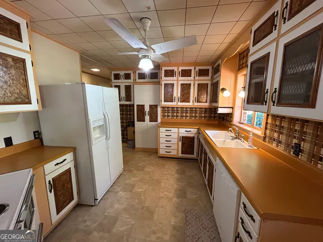 a kitchen with stainless steel appliances granite countertop a stove and a refrigerator