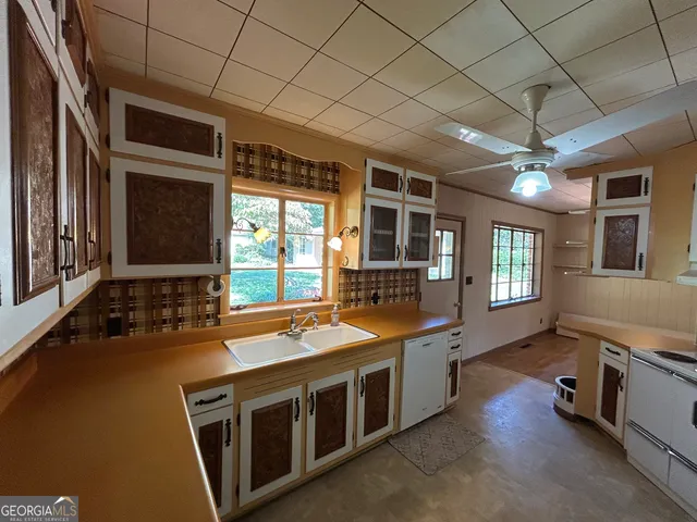 a bathroom with a sink mirror vanity and toilet