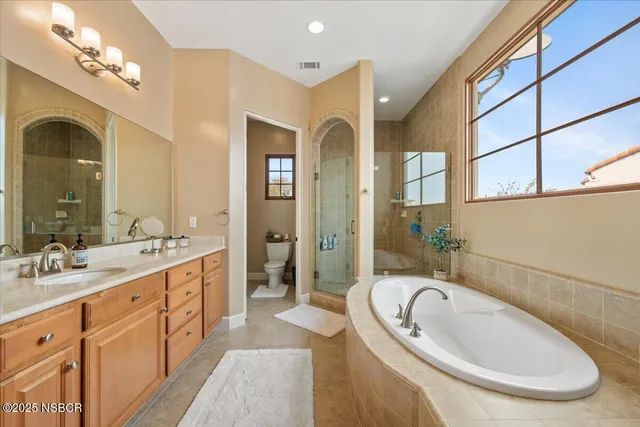 a bathroom with a granite countertop sink mirror bathtub and shower