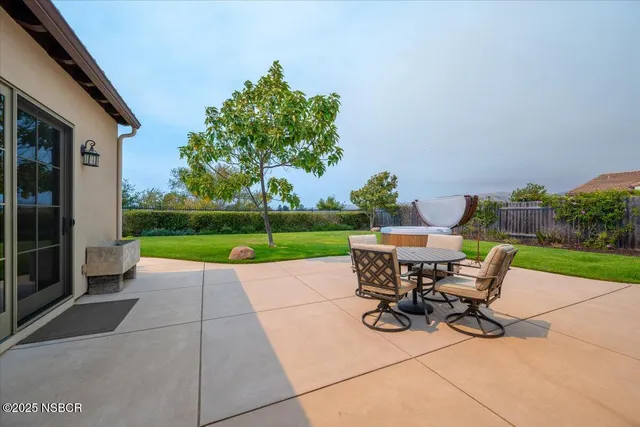 a view of a patio with a table and chairs