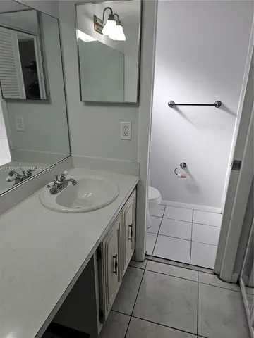 a white toilet sitting next to a bath tub