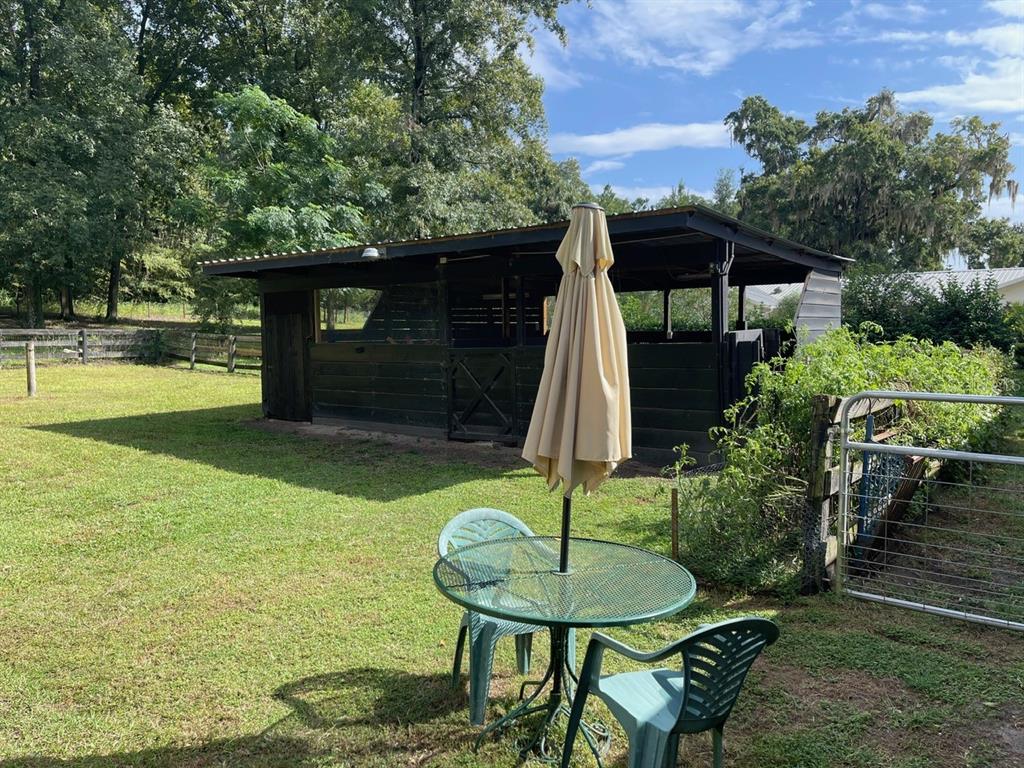 2309 Southwest 66th Street Ocala, FL 34476 - Photo 12 of 35 a backyard of a house with yard table and chairs