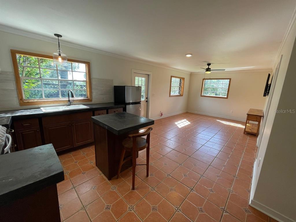 2309 Southwest 66th Street Ocala, FL 34476 - Photo 20 of 35 a kitchen with granite countertop a sink cabinets and window