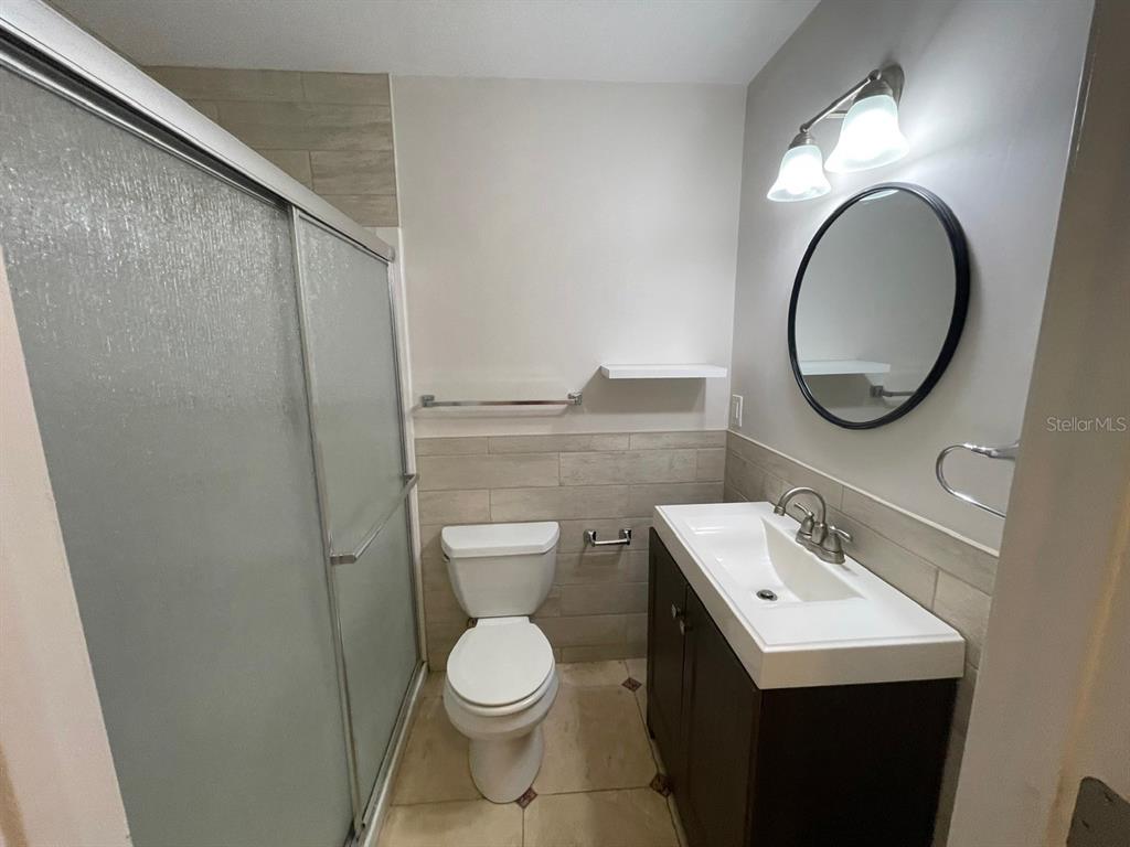 2309 Southwest 66th Street Ocala, FL 34476 - Photo 24 of 35 a bathroom with a toilet sink vanity and mirror