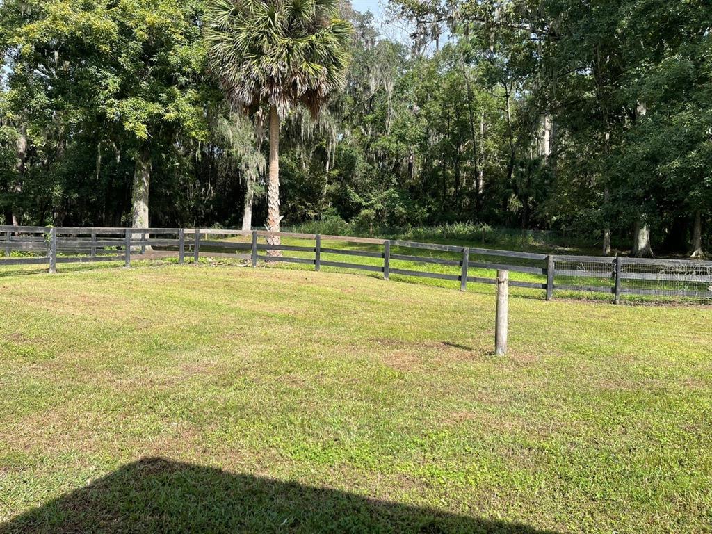2309 Southwest 66th Street Ocala, FL 34476 - Photo 31 of 35 a view of a swimming pool with a bench and trees around