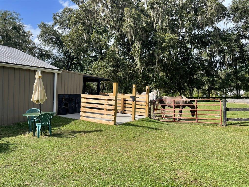 2309 Southwest 66th Street Ocala, FL 34476 - Photo 7 of 35 a backyard of a house with table and chairs