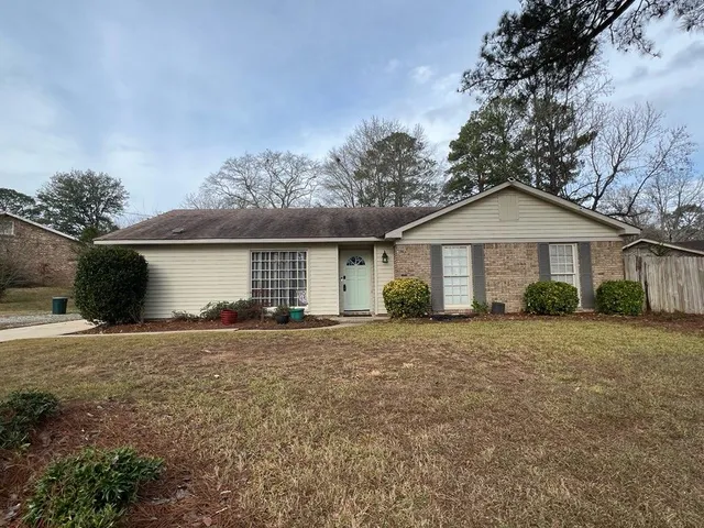 a view of a house with a yard and garage