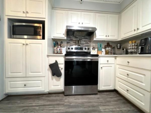 4405 Green Ridge Drive Columbus, GA 31909 - Photo 15 of 31 a kitchen with stainless steel appliances kitchen island granite countertop a stove and a microwave