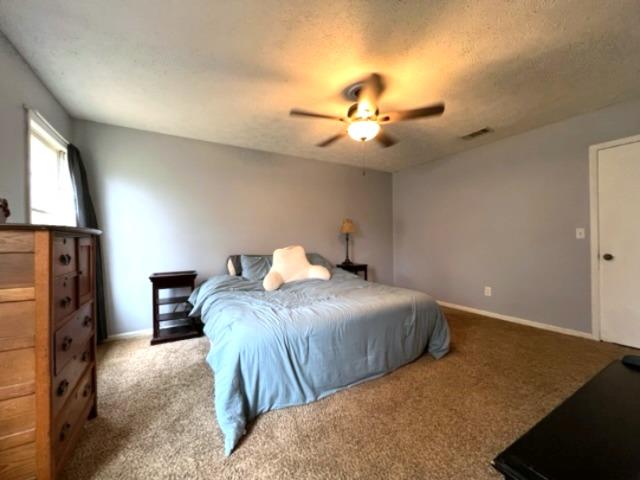 4405 Green Ridge Drive Columbus, GA 31909 - Photo 21 of 31 a bedroom with a bed and a chandelier