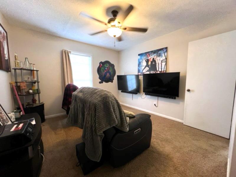 4405 Green Ridge Drive Columbus, GA 31909 - Photo 26 of 31 a living room with furniture a flat screen tv and a wall painting